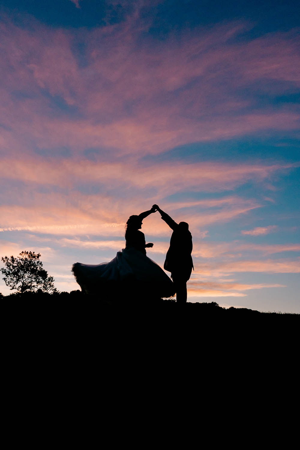 Bride and Groom Dance Outside at Sunset