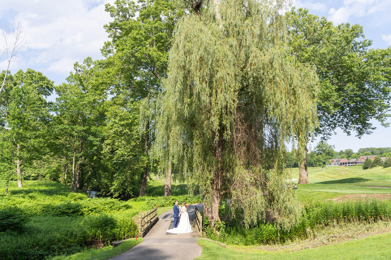 Bride and Groom Exchange Notes on Bridge at Hollow Brook Golf Club