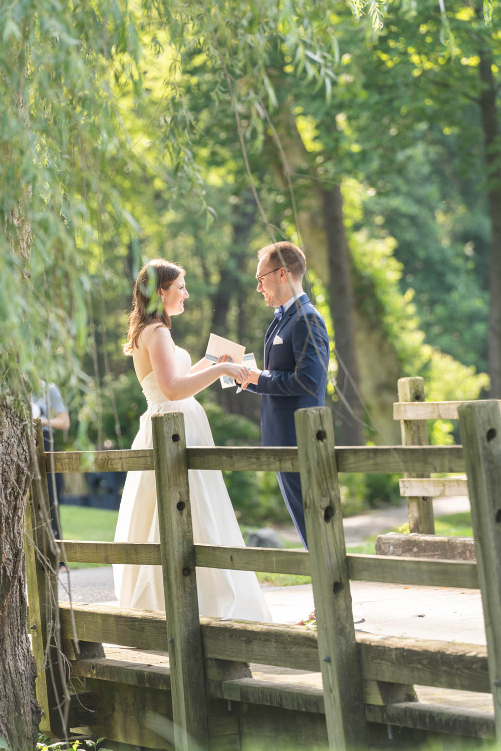 Bride and Groom Exchange Notes on Bridge at Hollow Brook Golf Club