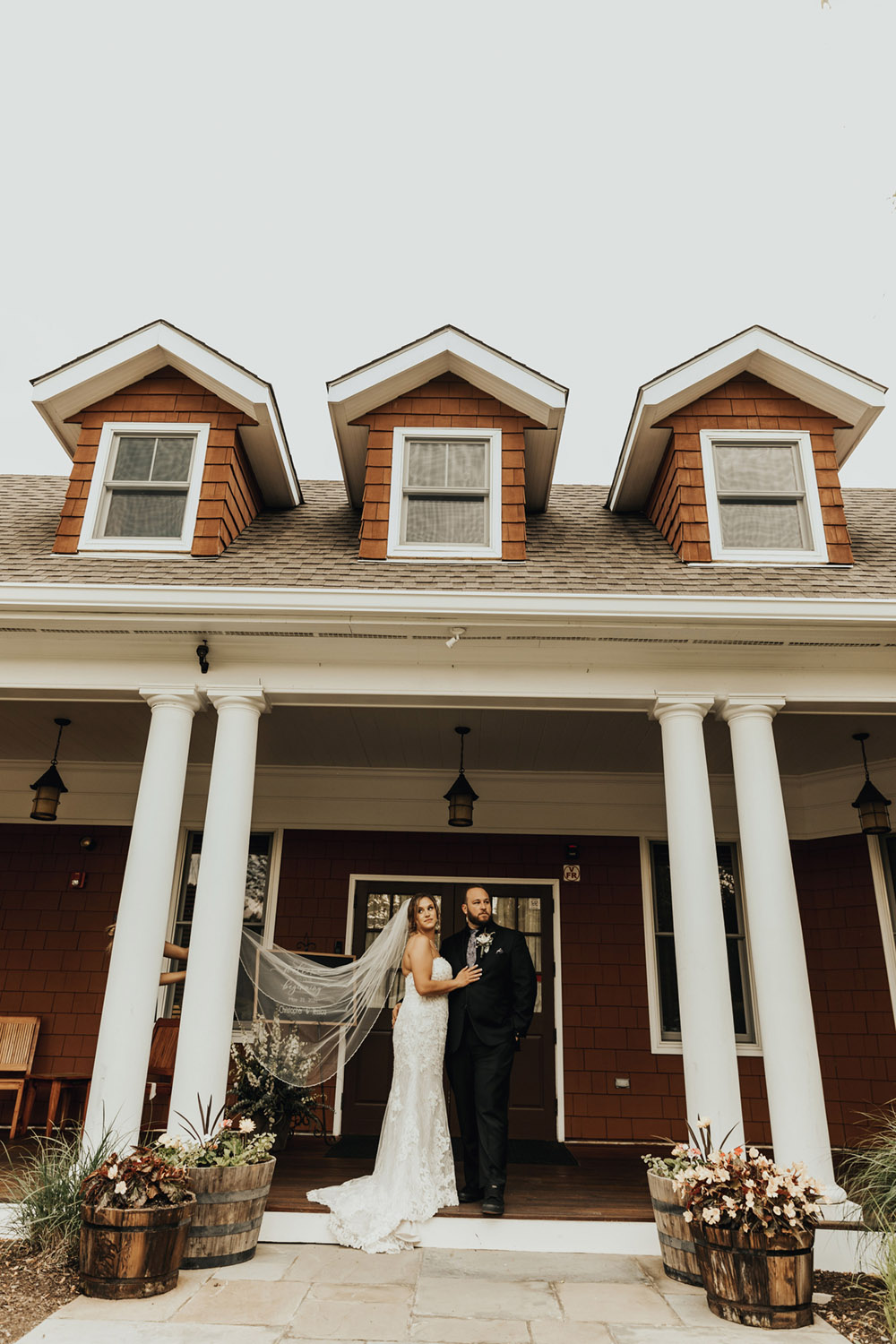 Bride and groom posing at the entrance of the golf course wedding venue in Cortlandt Manor, NY