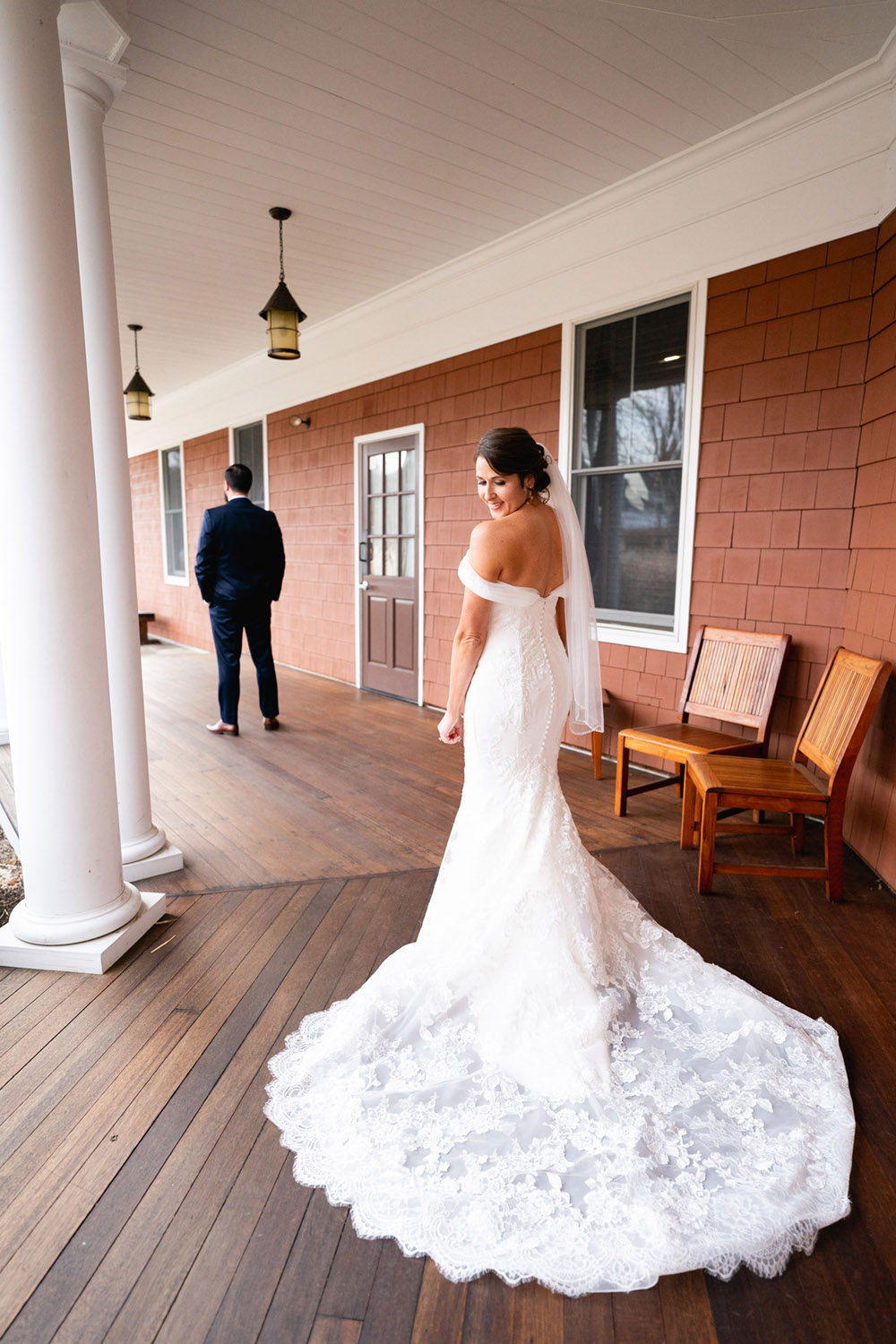 A bride wearing a pretty white dress, walking down the aisle at the wedding venue in Cortlandt Manor
