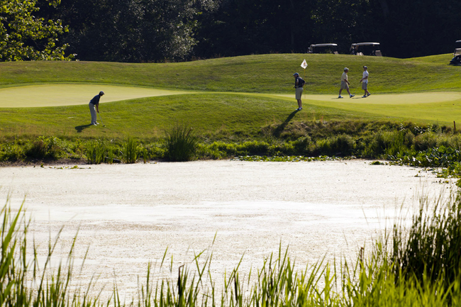Golfers playing Hole 6 near the lake at Hollow Brook Golf Club in Cortlandt Manor, NY