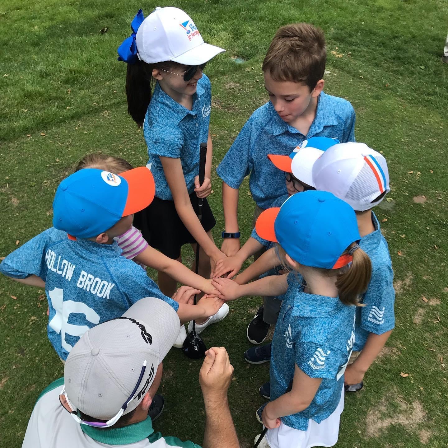 Junior golfers in team huddle at Hollow Brook Golf Club in Cortlandt Manor, NY
