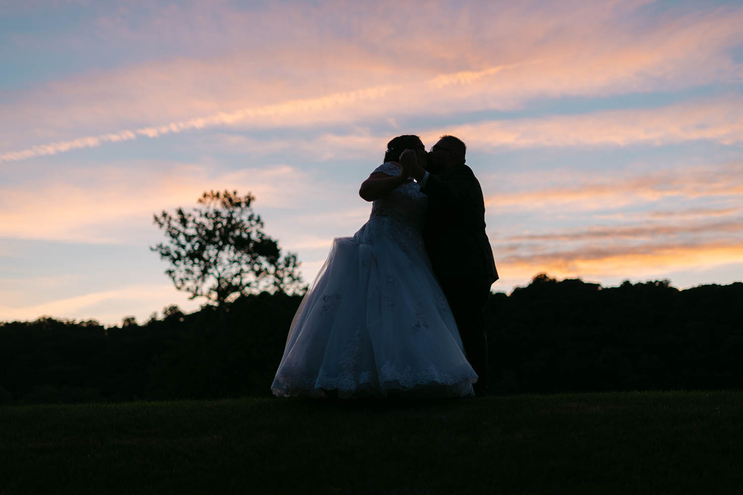 Bride and Groom Kiss Outside at Sunset