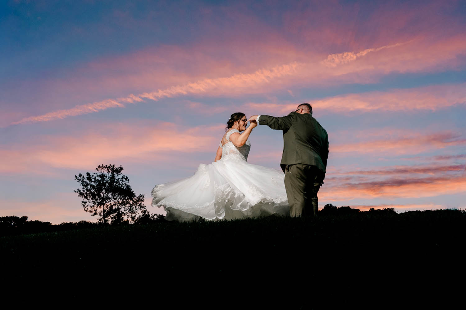 Bride and Groom Dance Outside at Sunset